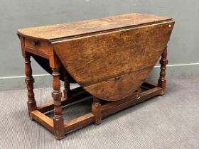 An 18th century oak gateleg table, with drawer, 158cm when open, 134cm deep