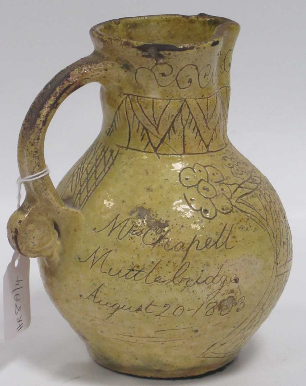 A 19th century saltglazed jug, the body incised Mrs Chapell / Muttlebridge / Augusy 20 - 1833,