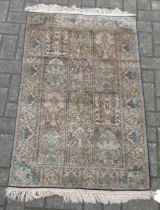 A silk Turkish Hereke rug with a blue and green ground colour 135 x 77 cm The rug is heavy