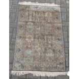 A silk Turkish Hereke rug with a blue and green ground colour 135 x 77 cm The rug is heavy