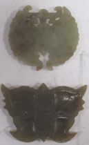 Two antique Chinese carved jade butterfly pendants, one of which is pale greenish-white (2)