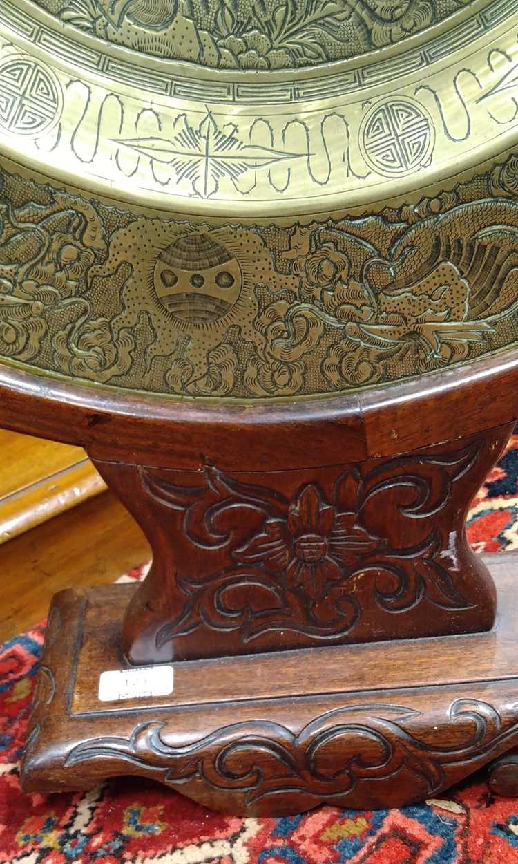 A Chinese circular brass dish on carved wood stand, early 20th century, decorated in relief with - Image 5 of 10