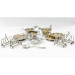 A collection of silverware including a cased set of four toast racks, sauceboats, ashtrays, cream