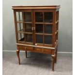 An Edwardian oak glazed cabinet on associated stand, two drawer base with scalloped frieze on