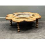 A Moorish brazier with metal bowl liner and shaped stand on bobbin turned feet, 101cm wide