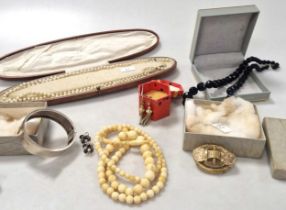 A collection of silver and costume jewellery including a base metal sovereign holder, a cameo brooch