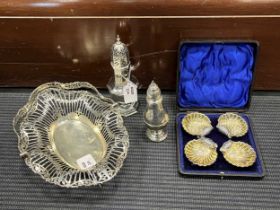 A silver swing handled cake basket, together with a cased set of four silver shell salts and two