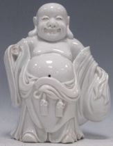 A Chinese white porcelain 'blanc de chine' of Budai, 18cm high