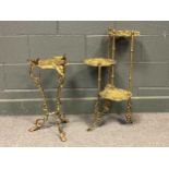 A pierced brass small tripod occasional table, each leg capped with a phoenix-like finial, 56cm