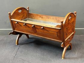 A 19th century Continental walnut and inlaid cradle,