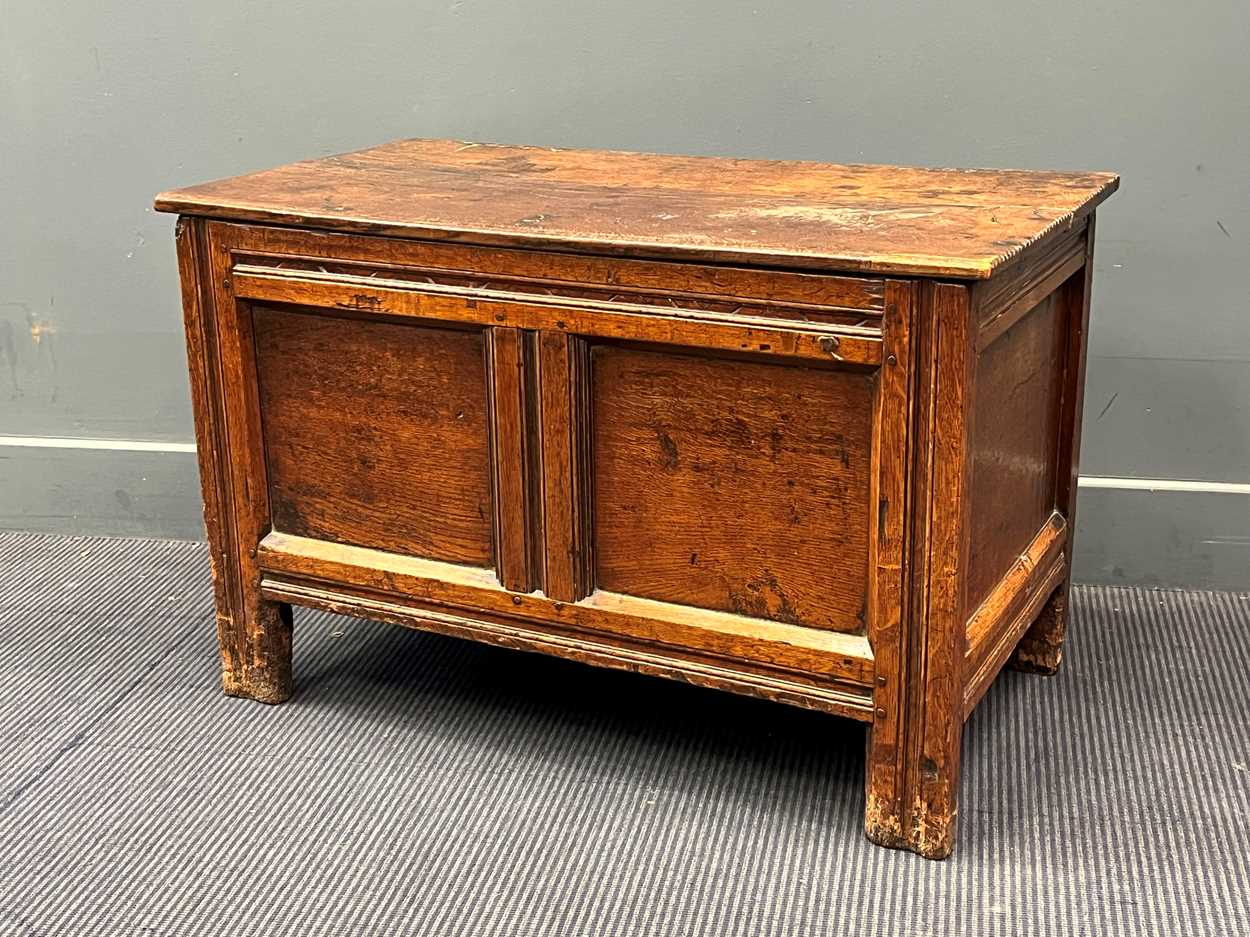 An oak two plank top blanket box with chip carved edge, early 18th century, 56.5 x 89 x 47cm