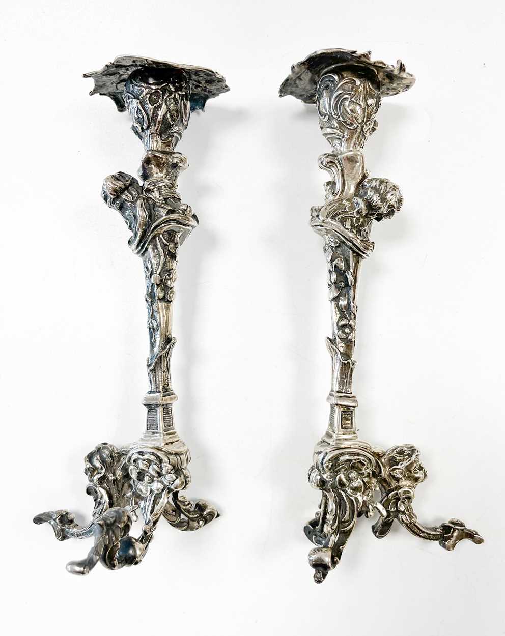 A pair of Continental silver cast candlesticks, decorated with heads, leaves and scrolls, damage and - Image 4 of 6