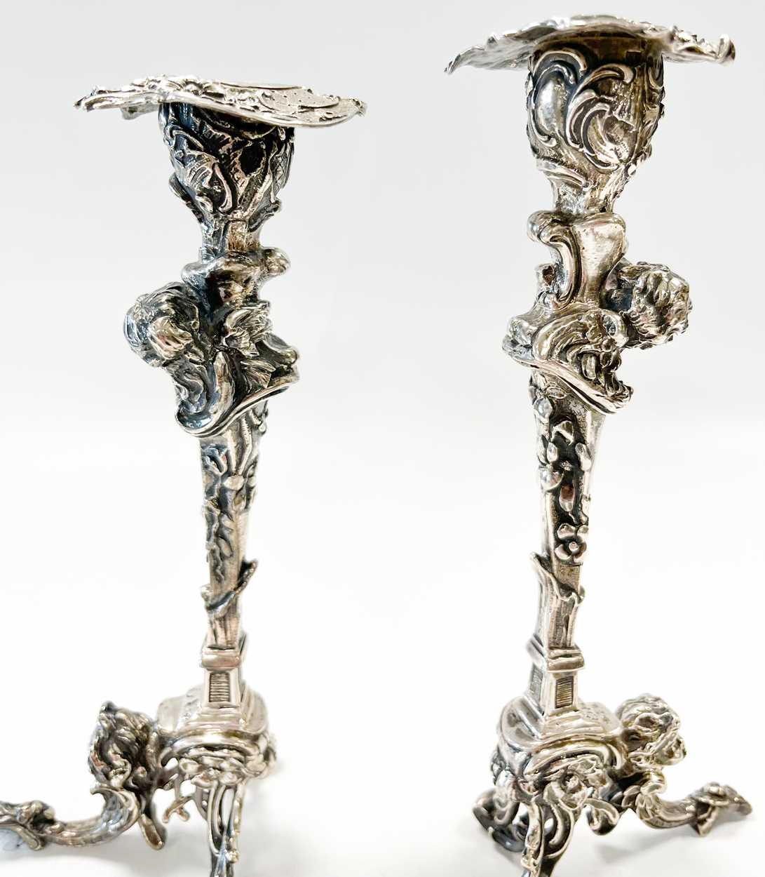 A pair of Continental silver cast candlesticks, decorated with heads, leaves and scrolls, damage and - Image 5 of 6