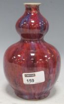 A Chinese flambe glaze double gourd vase, 19cm high Small chip and hairline crack to rim (shown in