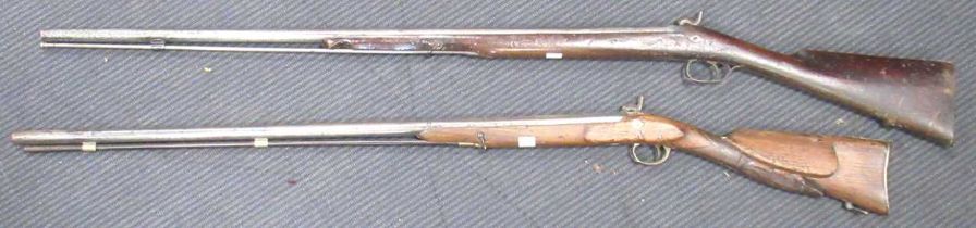 A 19th century percussion cap long gun and another Belgian example with carved wild boar to