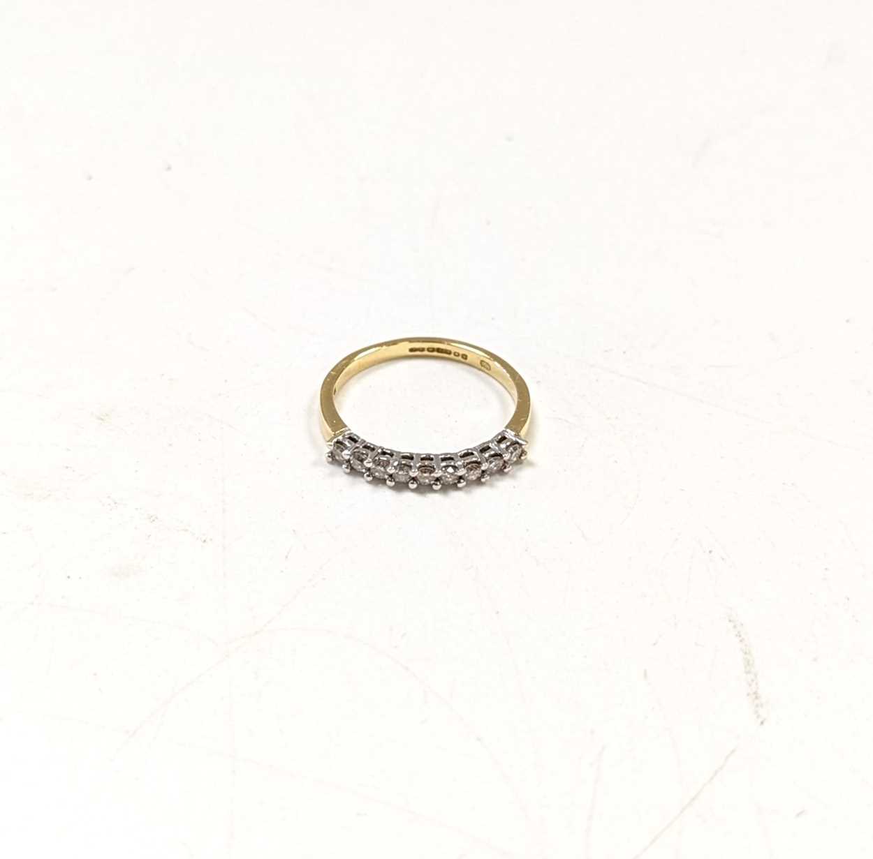 A hallmarked 18ct gold diamond set half hoop syle ring, estimated approximate total diamond weight