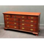 An American modern wild black cherry long chest of 9 drawers with gilt brass handles, by Henkel