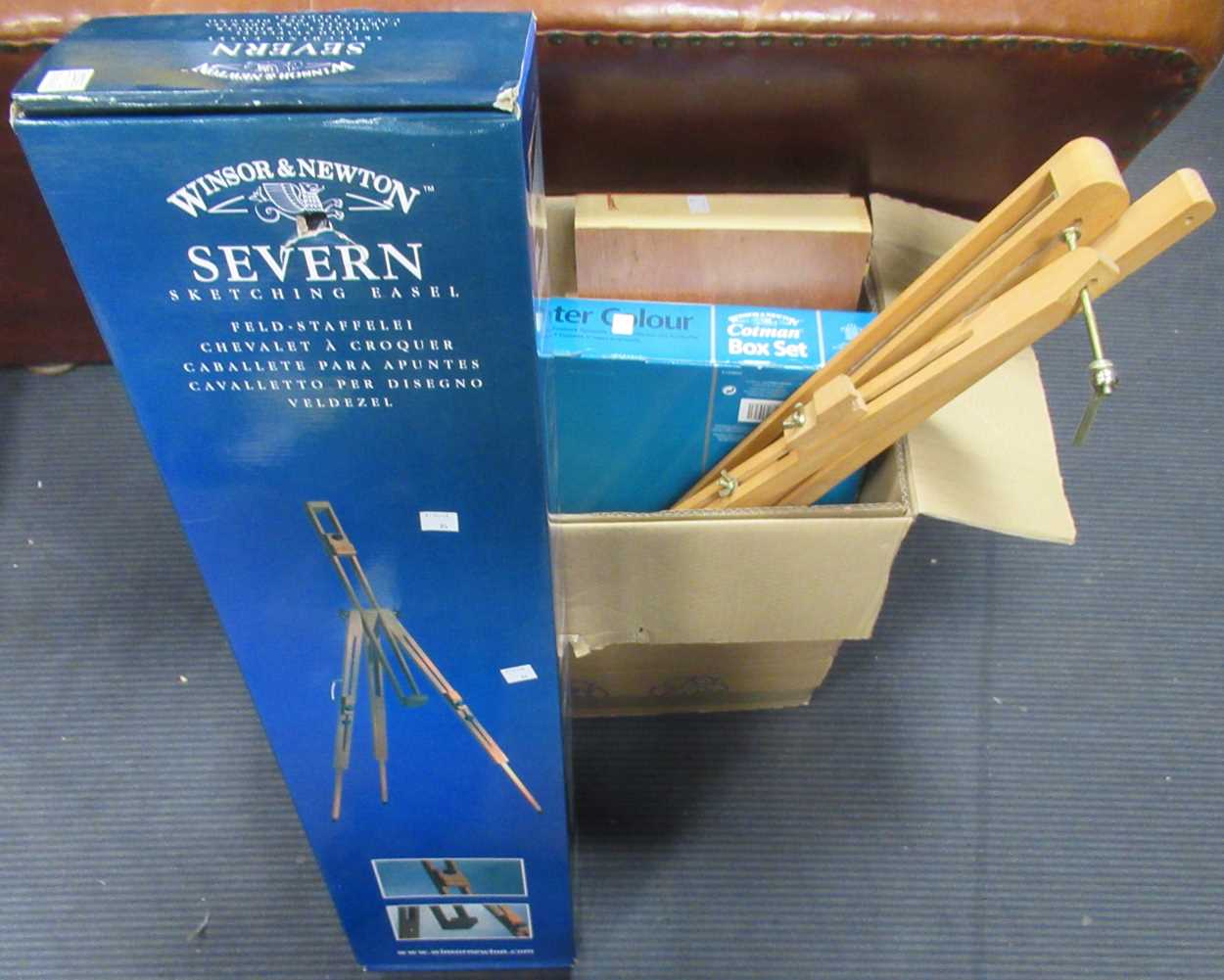 A collection of Windsor & Newton and other art supplies, including easels, paints and other