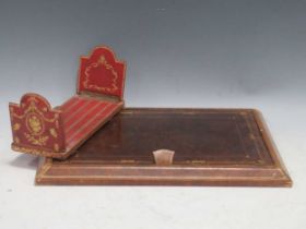 An embossed leather desk blotter; book stand: and two souvenir shell sailors valentines in anchor