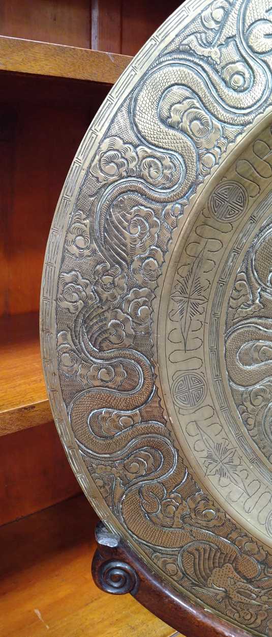 A Chinese circular brass dish on carved wood stand, early 20th century, decorated in relief with - Image 10 of 10