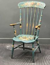An early 20th century painted comb back armchair with floral decoration Wear to the paint consistent