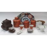 A Chinese red stoneware teapot and cover, three orange ground cannisters and covers. an imari