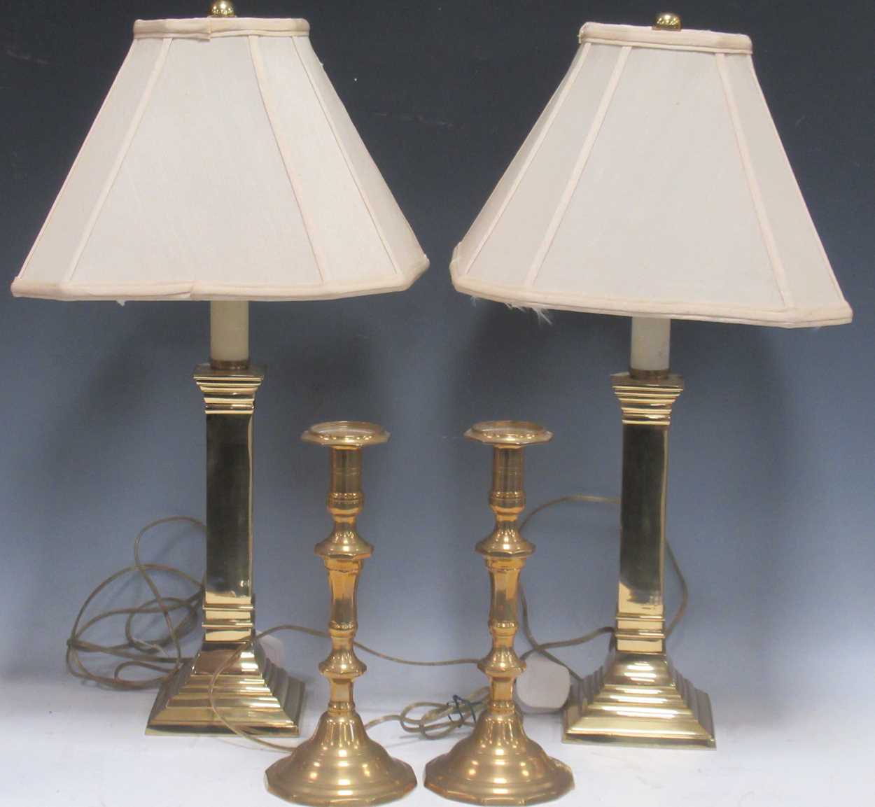 A pair of modern heavy polished brass table lamps, and a pair of brass candlesticks (4)