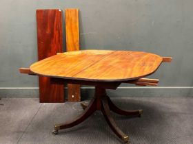 A 19th century mahogany tilt top dining table with two small leaves