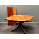 A 19th century mahogany tilt top dining table with two small leaves
