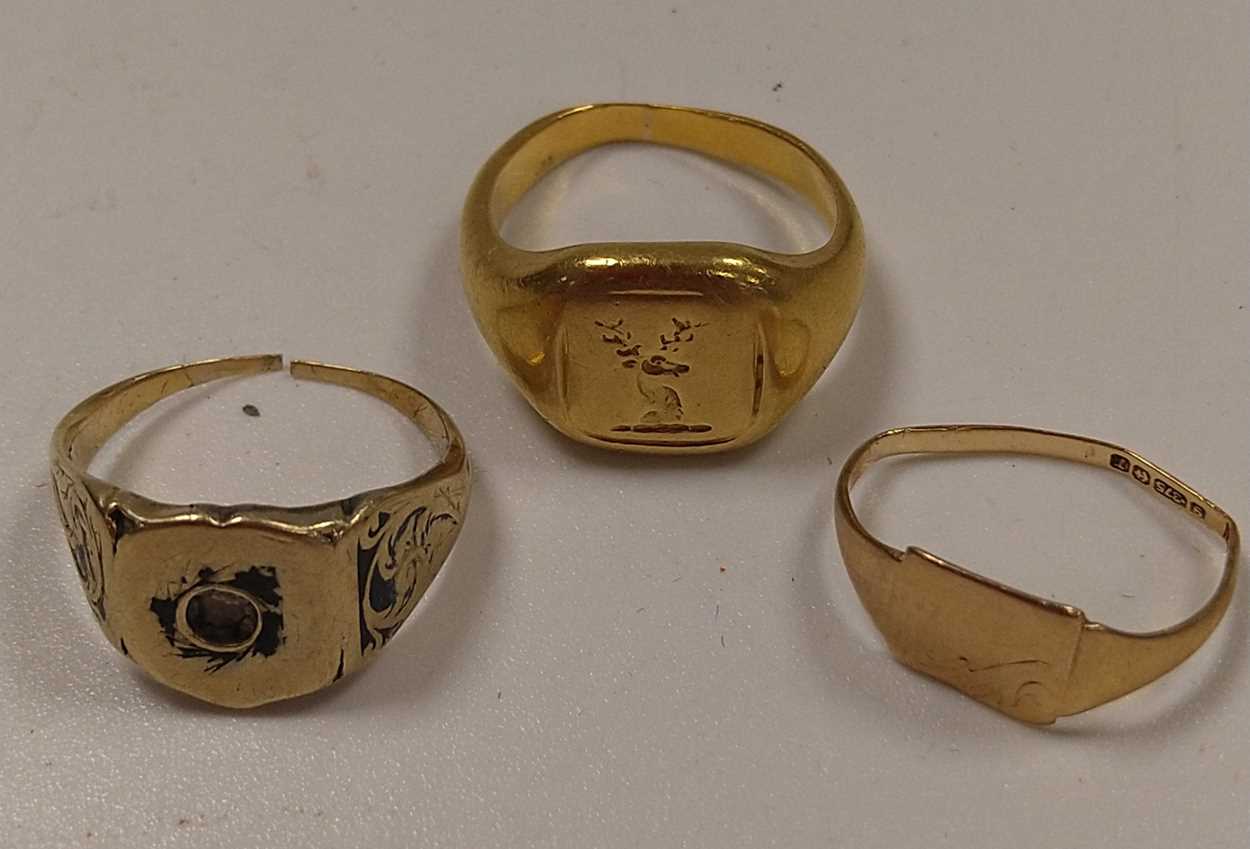 A signet ring tested to at least 18ct gold, weight 7.9g, together with two other signet rings,