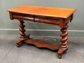 A Victorian walnut side table with two frieze drawers raised on heavy barley twist end supports 71 x