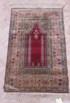 A vintage 'silk' prayer rug 140 x 74cm
