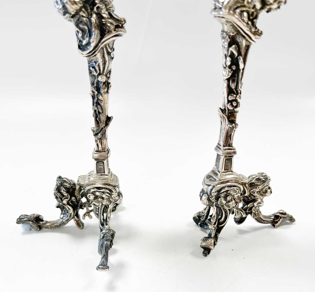 A pair of Continental silver cast candlesticks, decorated with heads, leaves and scrolls, damage and - Image 6 of 6