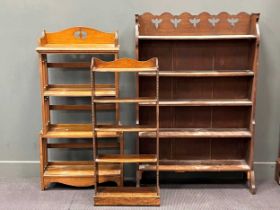 An oak Arts and Crafts book shelf with four open shelves and pierced arched sides 125 x 61 x 21cm,
