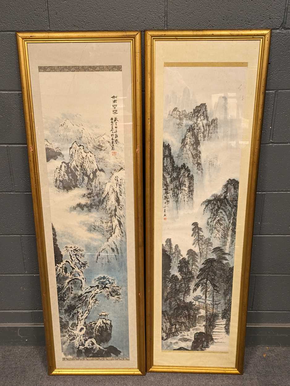 Two Chinese scroll paintings, both depicting landscapes, in gilt frames (2)