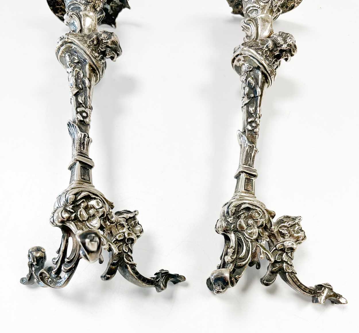 A pair of Continental silver cast candlesticks, decorated with heads, leaves and scrolls, damage and - Image 3 of 6