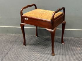 A late 19th century piano stool, with lift up seat supported on brass hinge, and cabriole leg with