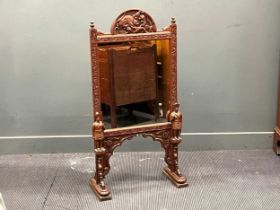 An early 20th century carved hardwood and mirrored fire screen, the arched top-rail with a scene
