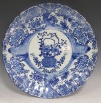 A 19th century Japanese blue and white charger with scalloped edge and central floral bouquet. 46cm