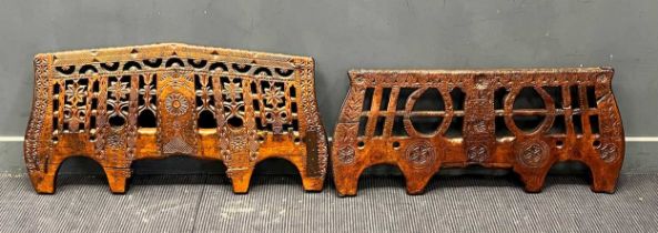 Two decorative Continental carved wood yokes, carved with pierced and incised decoration of