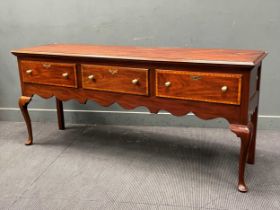 An American reproduction mahogany and crossbanded dresser, with gilt brass knob handles to three