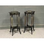 A pair of Edwardian style ebonised and parcel gilt torchères, with four fluted supports and out