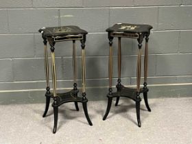 A pair of Edwardian style ebonised and parcel gilt torchères, with four fluted supports and out