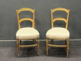 A pair of giltwood chairs