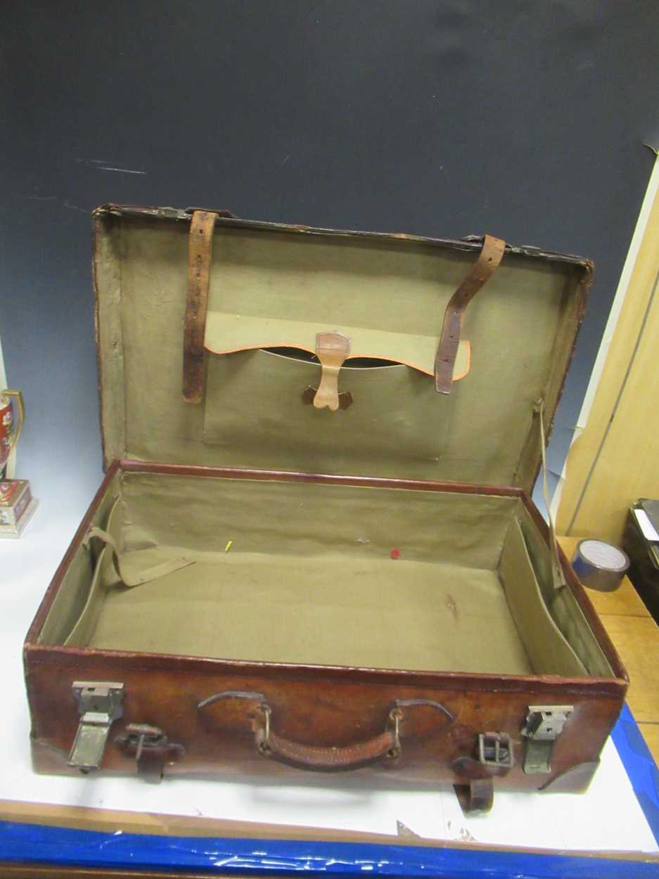 An early 20th century leather strapped suitcase locks by USA indistinctly stamped on the outside - Image 2 of 3