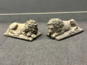 An opposing pair of cast stone recumbent lions on rectangular bases, after Canova 20 x 41 x 20cm