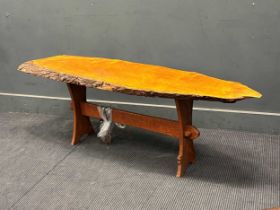 An Owlman coffee table, the sliced top with bark edge on end supports 50 x 150 x 42cm