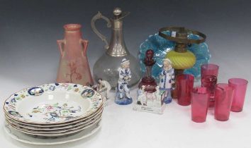 A collection of cranberry glass items to include a small Bohemian decanter, small glasses, a