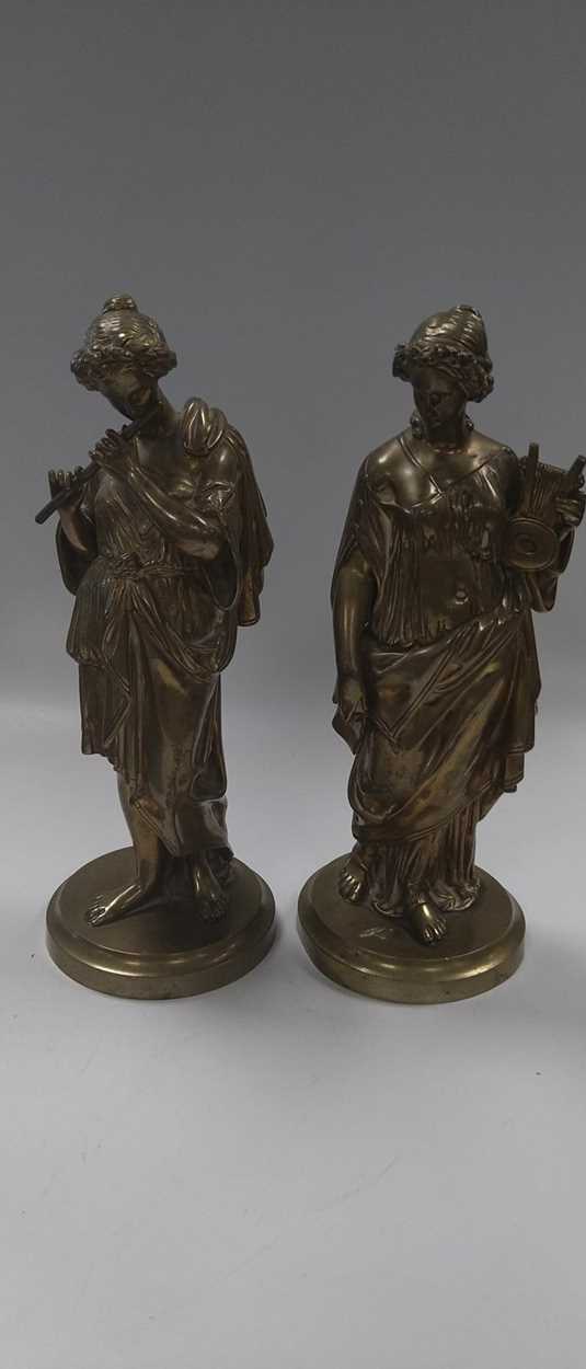 A pair of late 19th century bronze figures of female musicians in the classical style, with traces