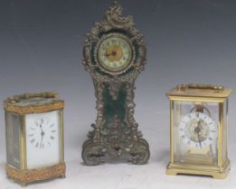 Two brass carriage clocks and a stained green faux tortoiseshell rococo style miniature clock